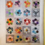 colorful hexi quilt blocks on the design wall