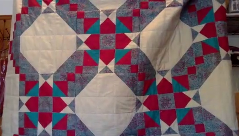 Quilt of white, gray, red