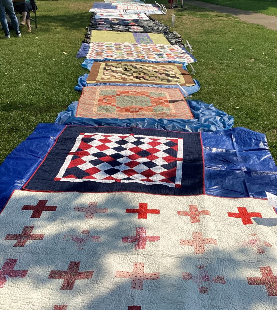 quilts spread on the grass